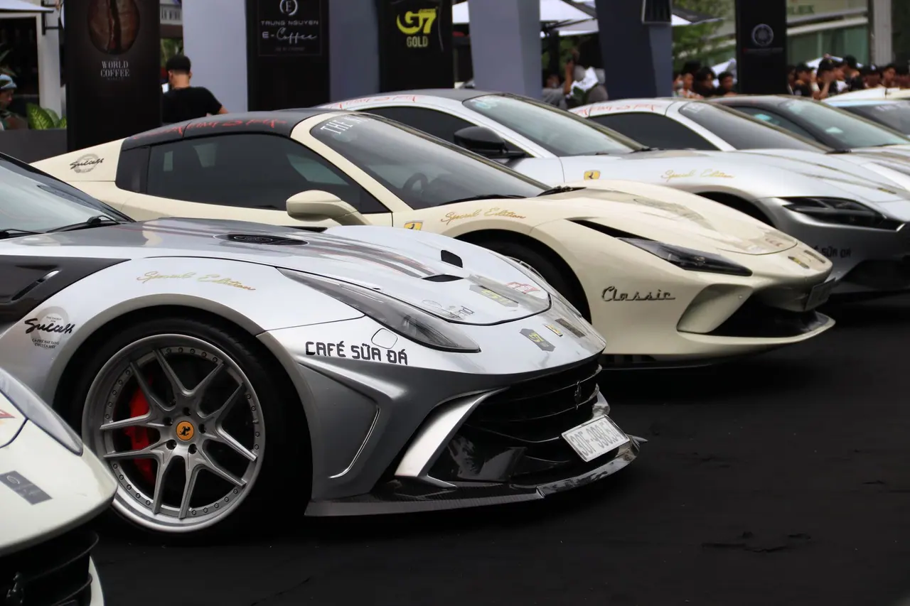 Sleek luxury sports cars on display at an outdoor car exhibition.